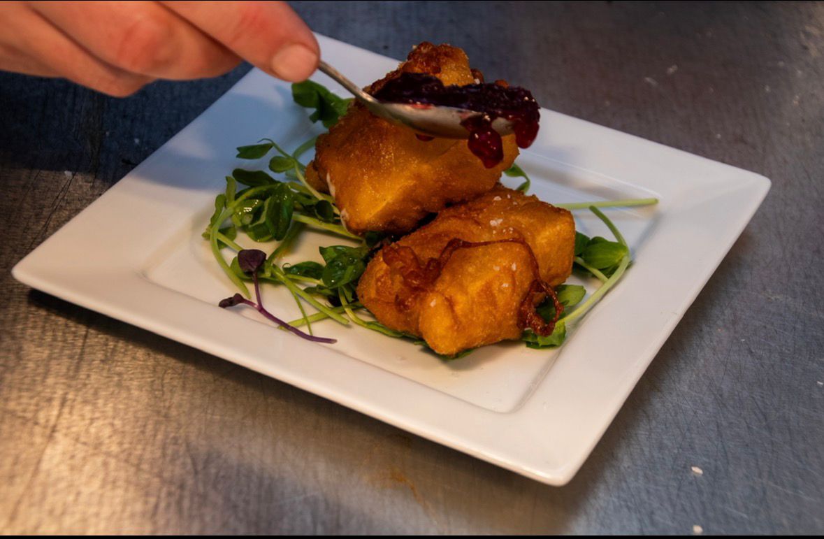 Crispy fried cheese bites with berry compote