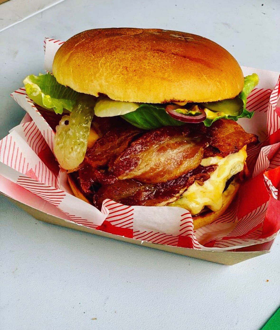 Bacon cheeseburger in a checkered tray