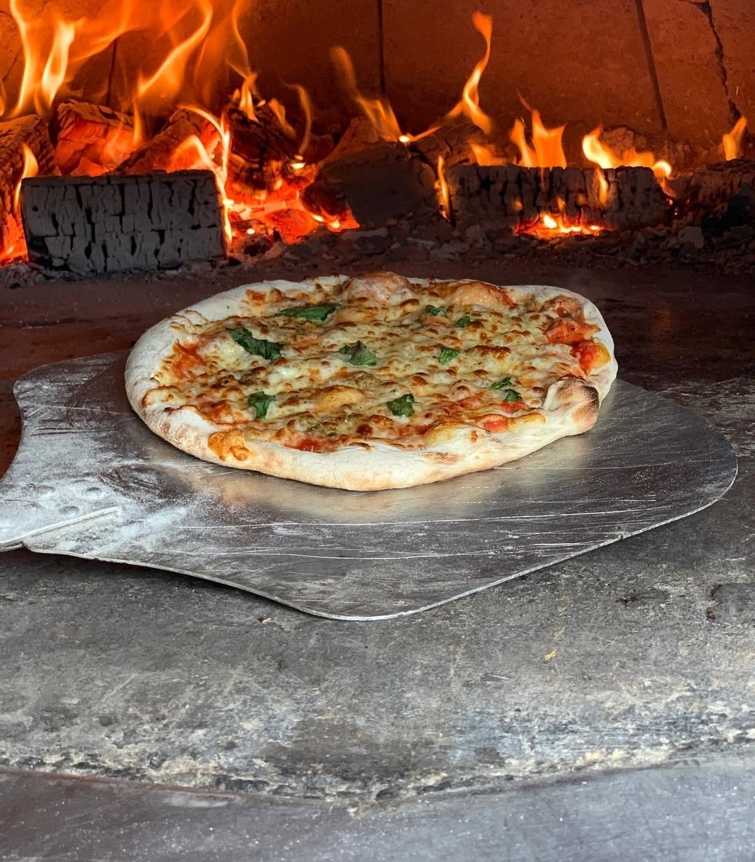 Margherita pizza fresh from the wood-fired oven
